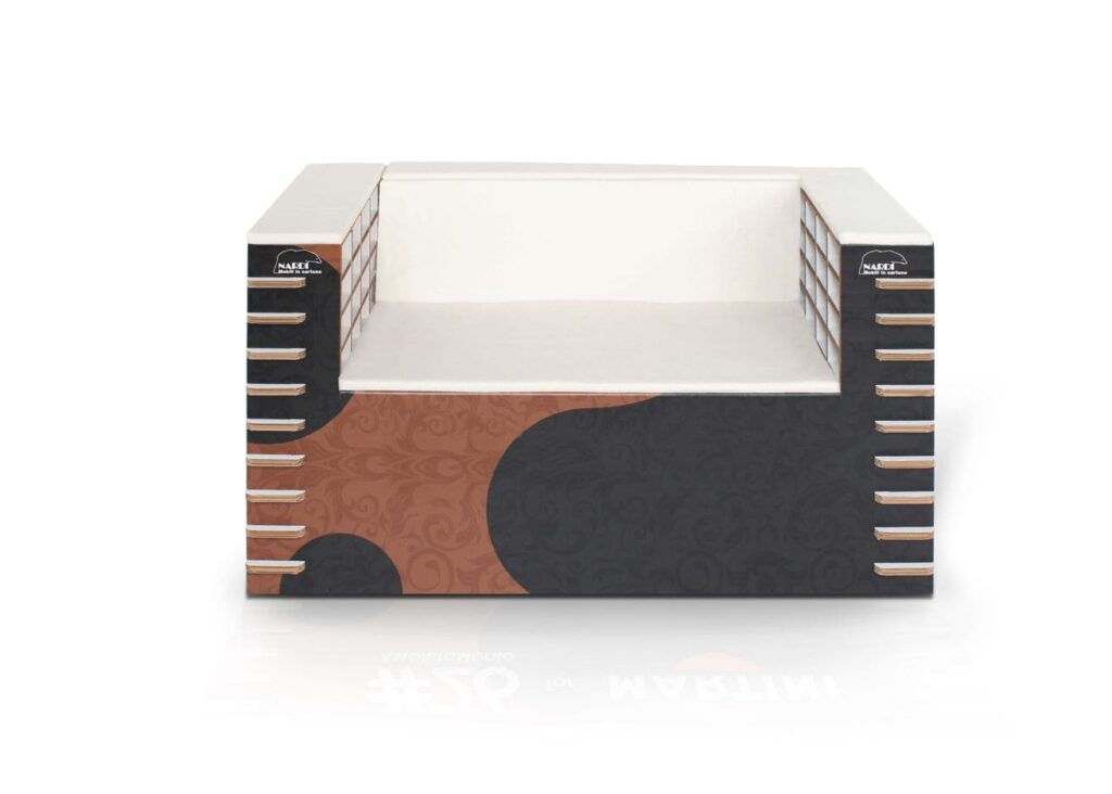 Canapé modulable en structure cartonnée avec coussins et coussinets décoratifs en tissu brodé, idéal pour espaces de travail ou bureaux créatifs. Design épuré avec finition métallique des poignées et supports latéraux, parfait pour un intérieur professionnel ou convivial - Le Meuble en Carton une marque du groupe Natur Design